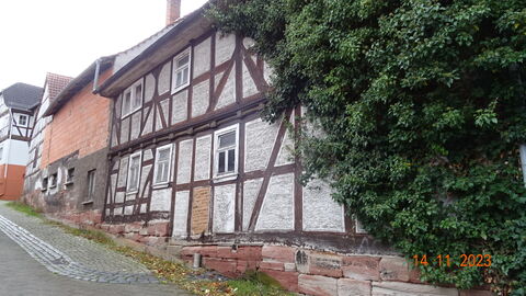 Fachwerkfassade auf Sockel aus rotem Sandstein