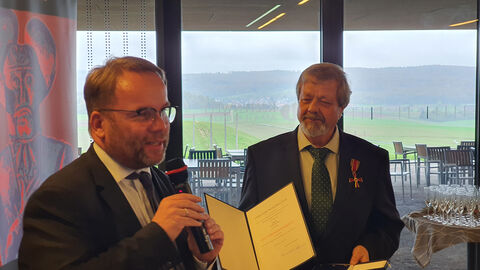 Staatsminister Timon Gremmels überreichte die Auszeichnung an Werner Erk direkt am Ort des Geschehens: in der Keltenwelt am Glauberg. Staatsminister Timon Gremmels und Werner Erk.